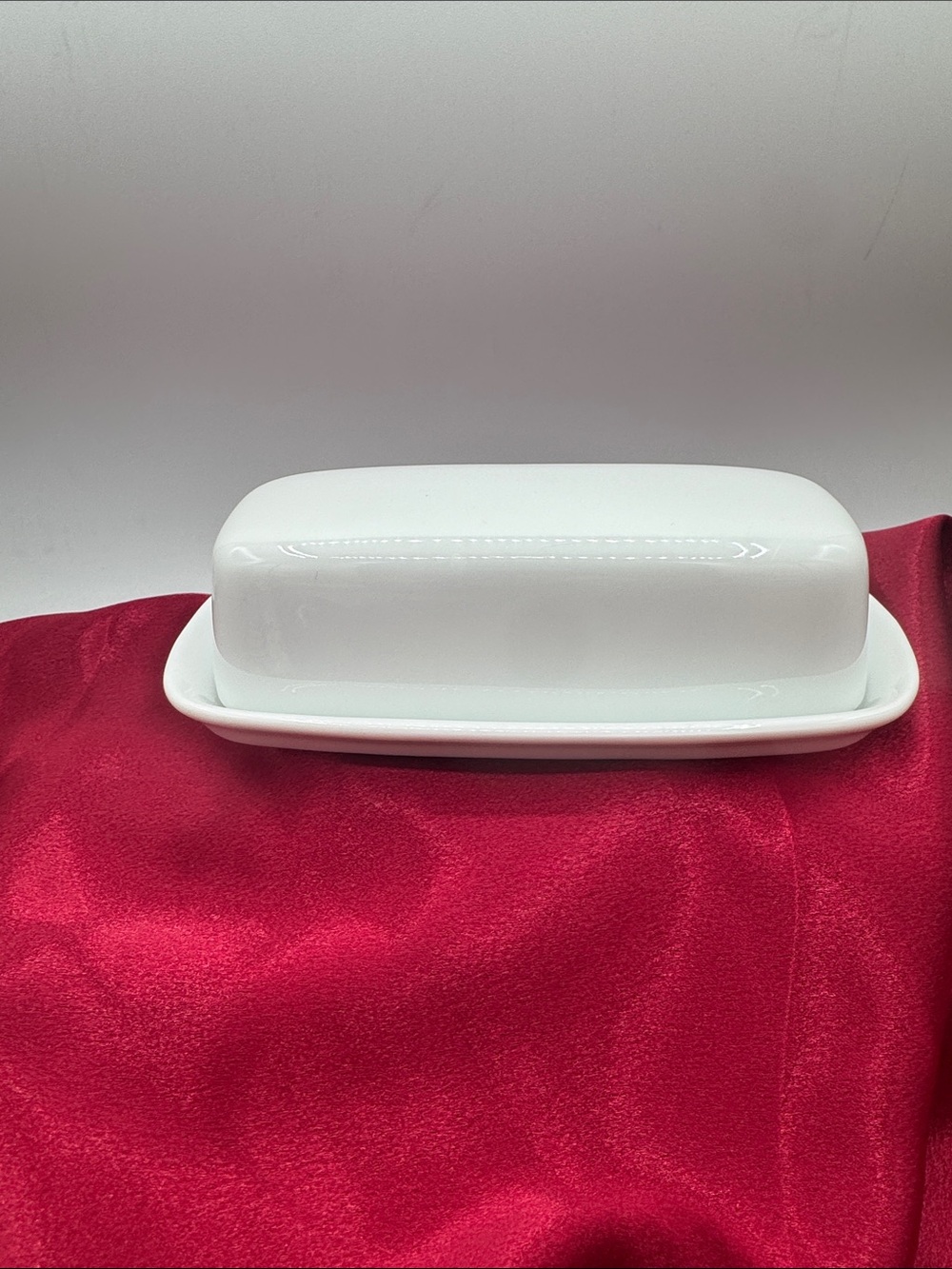 A vintage Corning minimalist design white covered butter dish.